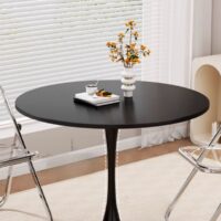 A sleek and stylish Modern Round Tulip Dining Table with a minimalist design, featuring a smooth tabletop and a single, elegant pedestal base.