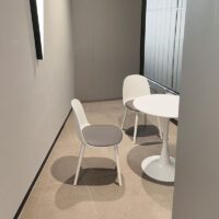 A sleek, round modern tulip dining table with a smooth white tabletop and a single pedestal base, ideal for contemporary dining rooms.