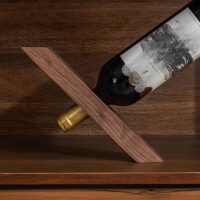 Wooden wine holder with an elegant design, holding two bottles of wine.