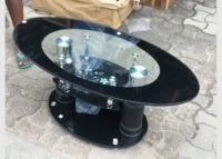 A stylish glass-topped coffee table with a sleek tempered glass surface and a sturdy base, adding elegance and modern appeal to any living space.