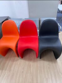 The Vitra Panton Chair, a sleek and sculptural modern chair made from a single molded piece of plastic, designed for style and comfort.
