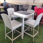 A stylish raised patio set with weather-resistant materials, comfortable seating, and a modern design, perfect for outdoor relaxation.