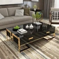 Modern living room coffee table with sleek design, glass top, and metal legs, placed in a stylish living room setting.