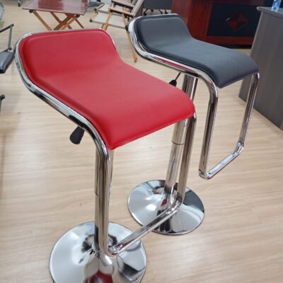 The Replica Lem Barstool features a sleek, cantilevered design with an adjustable height, swivel function, and a sturdy metal frame.