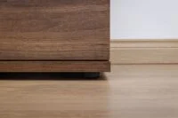 A stylish chest of drawers with multiple storage compartments, crafted from durable wood and featuring a sleek, modern design.