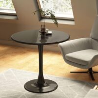 A stylish round dining table with a smooth surface, designed for comfort and conversation, surrounded by elegant chairs in a cozy dining space.