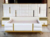 Large luxurious modern bed with a sleek design and plush upholstery for ultimate comfort.