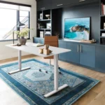 Electric height adjustable home desk with a sleek wooden top and black metal legs, featuring a control panel for height adjustment.