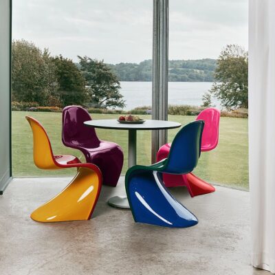 A set of Verner Panton-inspired modern dining chairs featuring smooth, curved plastic seats and a bold, sculptural design perfect for contemporary interiors.