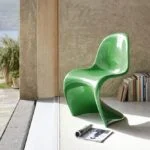 A sleek Verner Panton plastic modern dining chair with a curved design, made from durable material, perfect for contemporary dining rooms.