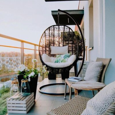 A cozy outdoor hammock swing with soft cushions, suspended by durable ropes, perfect for relaxing in your backyard or patio.