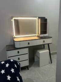 Modern vanity dressing table with built-in LED lights, sleek design, spacious drawers, and a stylish mirror, perfect for any contemporary bedroom.