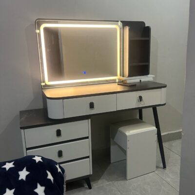 Modern vanity dressing table with built-in LED lights, sleek design, spacious drawers, and a stylish mirror, perfect for any contemporary bedroom.