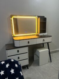 Modern vanity dressing table with built-in LED lights, sleek design, spacious drawers, and a stylish mirror, perfect for any contemporary bedroom.