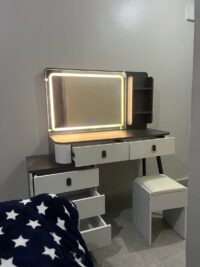 Modern vanity dressing table with built-in LED lights, sleek design, spacious drawers, and a stylish mirror, perfect for any contemporary bedroom.