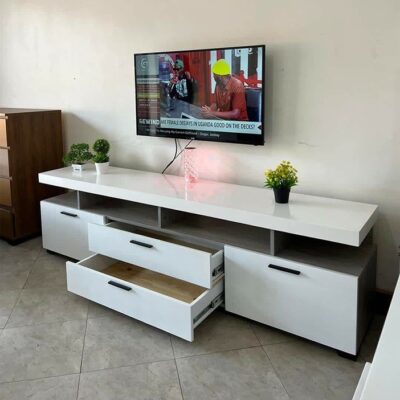 Contemporary TV stand with sleek design, featuring spacious shelves and a minimalist aesthetic.