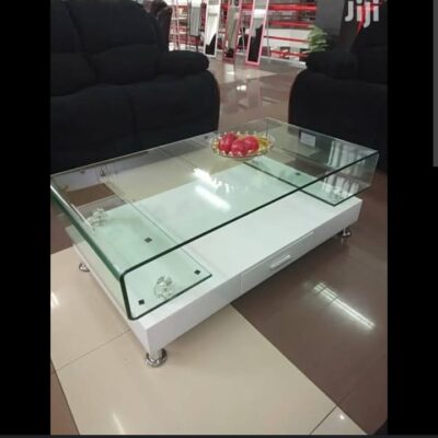 Elegant glass top coffee table with a sleek metal or wooden base, perfect for modern and contemporary living room decor