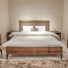 Contemporary Wooden Bed with sleek lines and a minimalist design in oak or walnut, featuring a low-profile frame and elegant wood finish.