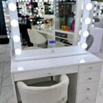 Elegant vanity makeup table with a mirror, drawers, and a sleek design, perfect for organizing cosmetics and beauty essentials.