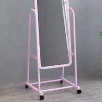A free-standing, full-length cheval mirror with a swiveling frame, designed for adjustable viewing and elegant room decor.