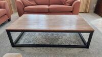 A sleek and modern Streamline Coffee Table with a minimalist design, sturdy construction, and ample surface space for décor and essentials.