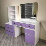 Sleek modern dressing table with a spacious tabletop, storage drawers, and an LED-lit mirror, perfect for makeup and beauty routines.