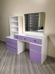 Sleek modern dressing table with a spacious tabletop, storage drawers, and an LED-lit mirror, perfect for makeup and beauty routines.