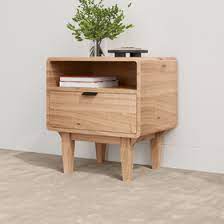 A wooden bedside cabinet featuring drawers and a shelf for storage, adding a classic touch to any bedroom decor.