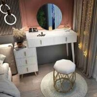 Elegant vanity table with mirror and storage drawers, perfect for makeup and grooming in a stylish bedroom setting.