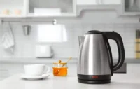 A sleek 1.8L stainless steel cordless kettle on a kitchen countertop, designed for fast and efficient boiling.