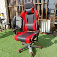Ergonomic red and black gaming chair with lumbar support and adjustable features for enhanced comfort during long gaming sessions.