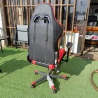 Ergonomic red and black gaming chair with lumbar support and adjustable features for enhanced comfort during long gaming sessions.