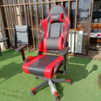 Ergonomic red and black gaming chair with lumbar support and adjustable features for enhanced comfort during long gaming sessions.