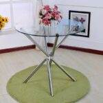 Sleek modern glass home dining table with a minimalist design and sturdy base, perfect for contemporary dining rooms.