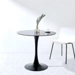 Elegant round mid-century dining table with a wooden base and sleek, minimalist design, perfect for modern dining rooms.