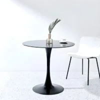 Elegant round mid-century dining table with a wooden base and sleek, minimalist design, perfect for modern dining rooms.