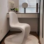 Verner Panton dining chair with iconic curved design and vibrant color, perfect for modern dining rooms or contemporary spaces.
