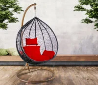 Colorful outdoor hammock swing hanging between two trees, perfect for relaxation in a garden or patio.